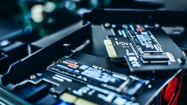 Two NVMe NAND SSD sticks, one sitting on top of the other.